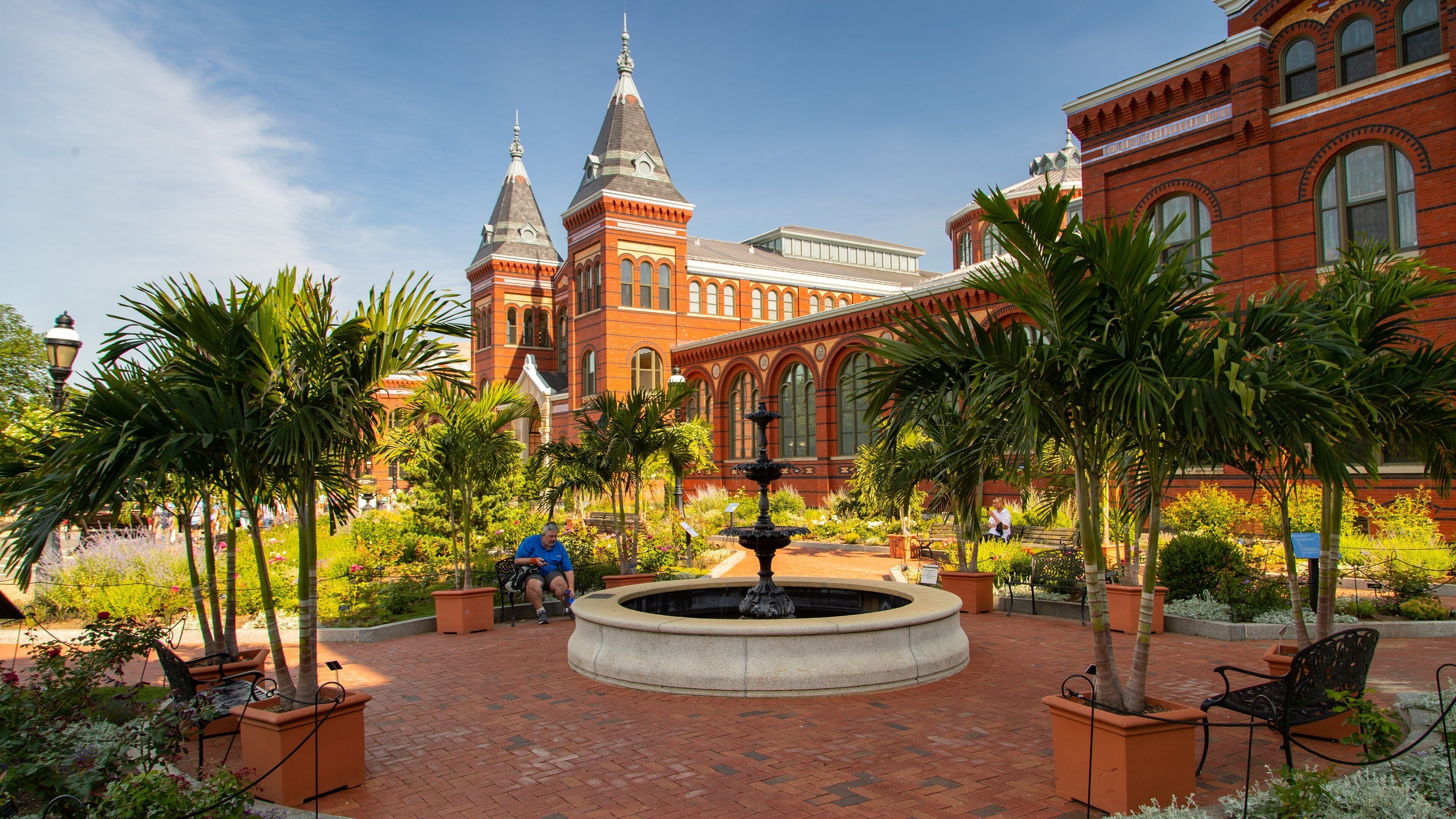 Arts and Industries Building featuring a fountain, a garden and heritage elements