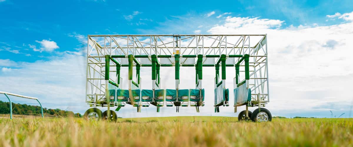 Ground level view on a race course of turnstiles used on a famous horse racing track in Newmarket, Suffolk, UK. Used to train horse and jockey of starting a race.