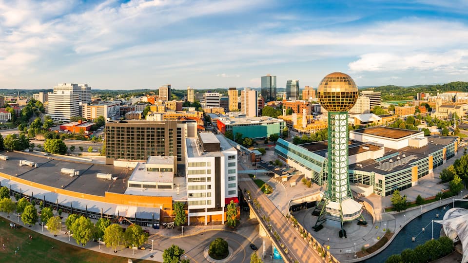 A cityscape with a prominent spherical building, a large dome, and a river.