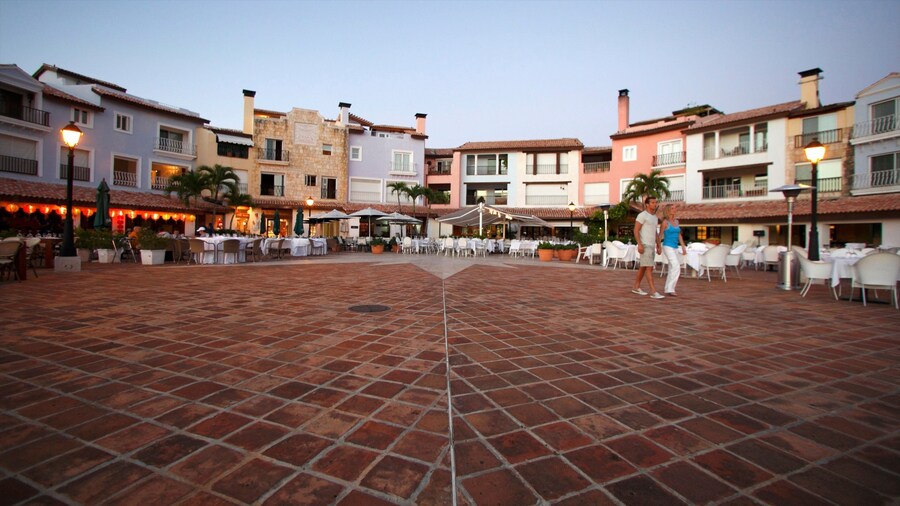 Casa de Campo Marina which includes a square or plaza and a sunset as well as a couple