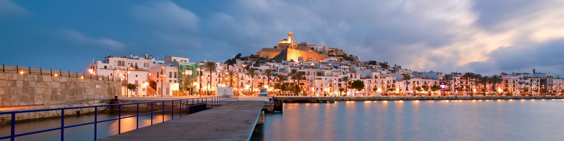 Ibiza Castle showing a sunset, a city and a bay or harbor