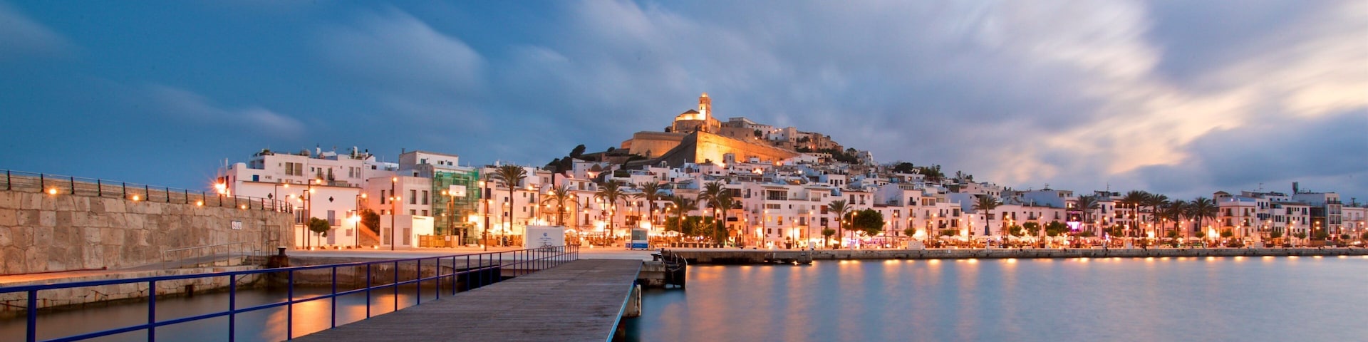 Ibiza Castle showing a sunset, a city and a bay or harbor