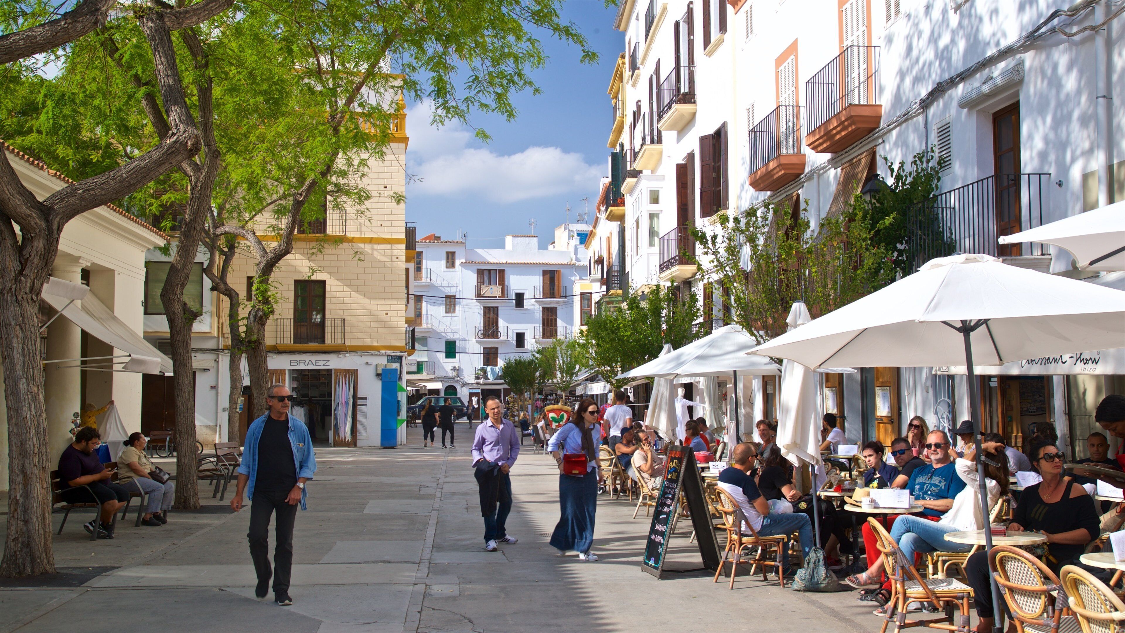 Sa Penya which includes street scenes and outdoor eating as well as a small group of people
