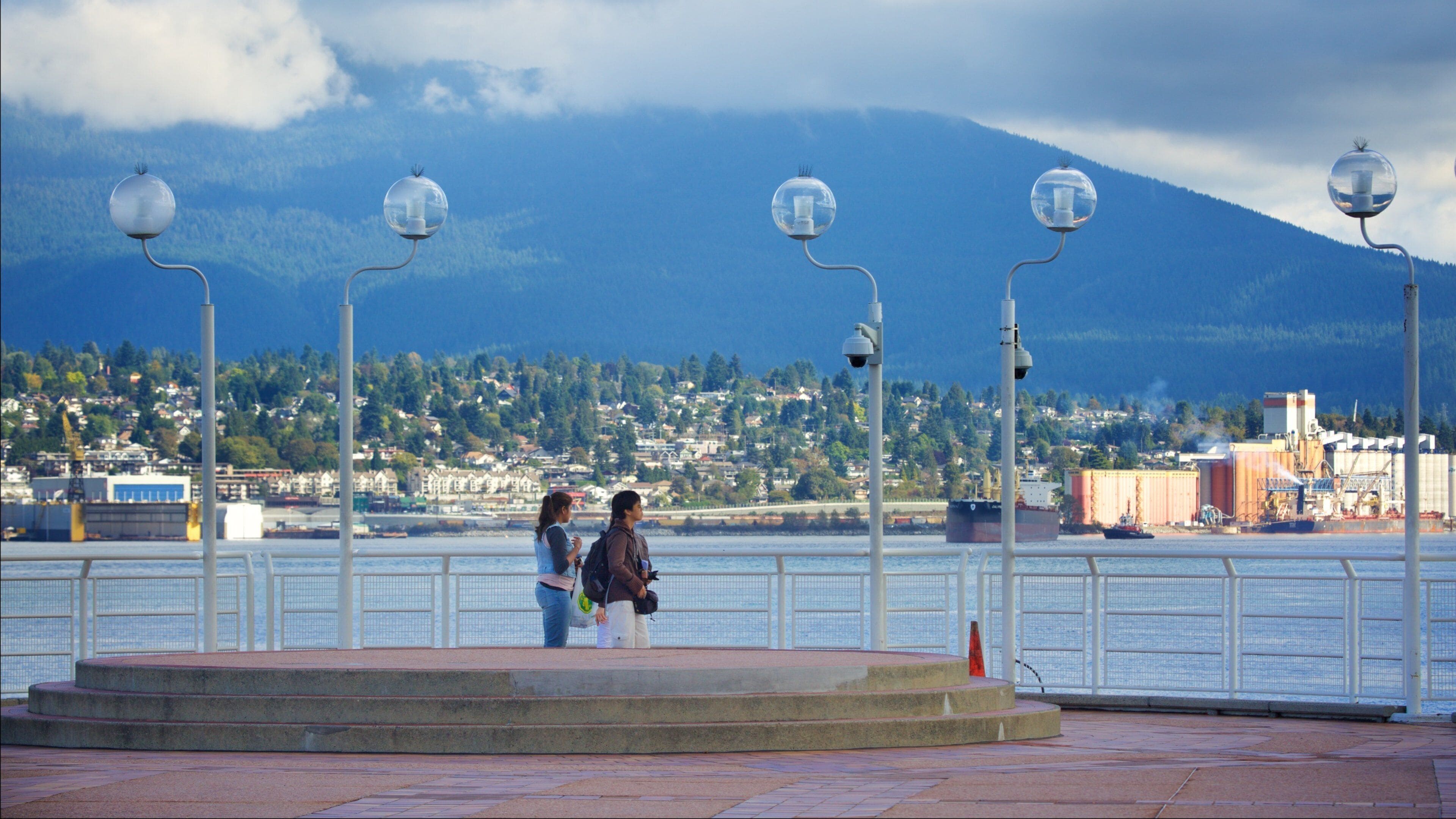 Vancouver Waterfront which includes a bay or harbor as well as a small group of people