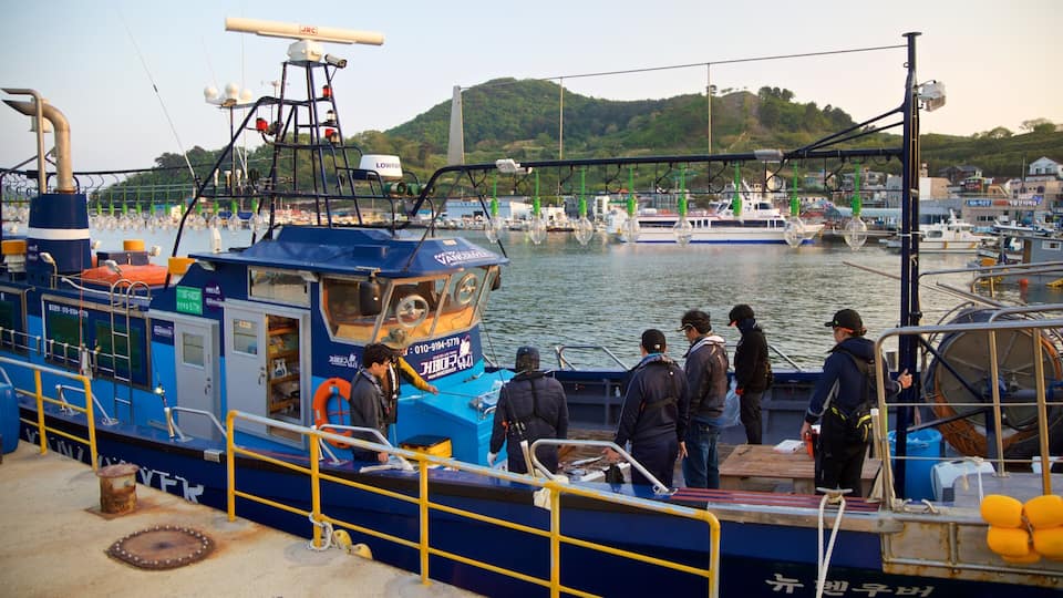 Gujora Beach showing a bay or harbor as well as a small group of people