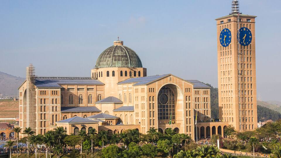 A large building with a dome and a clock tower.