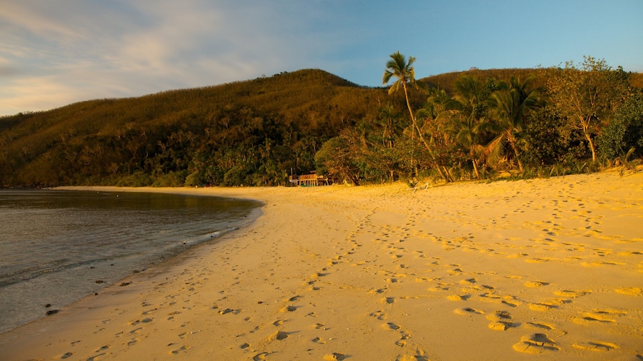 Discover the serene beauty of Naviti Island in Fiji at sunset with golden sands and lush landscapes