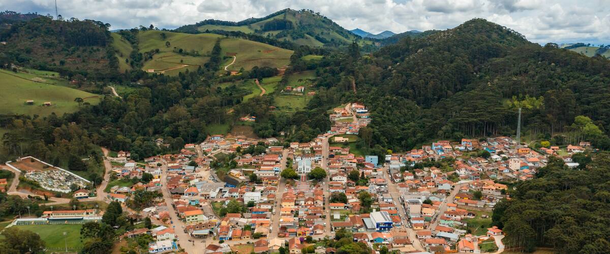 A town nestled in a valley surrounded by hills, with a mix of residential and commercial buildings.