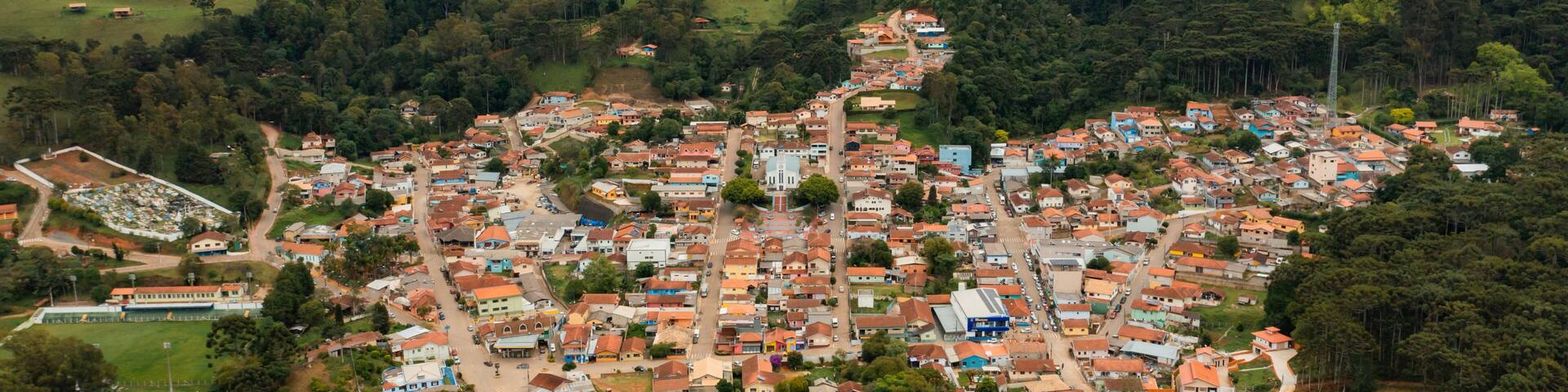 A town nestled in a valley surrounded by hills, with a mix of residential and commercial buildings.