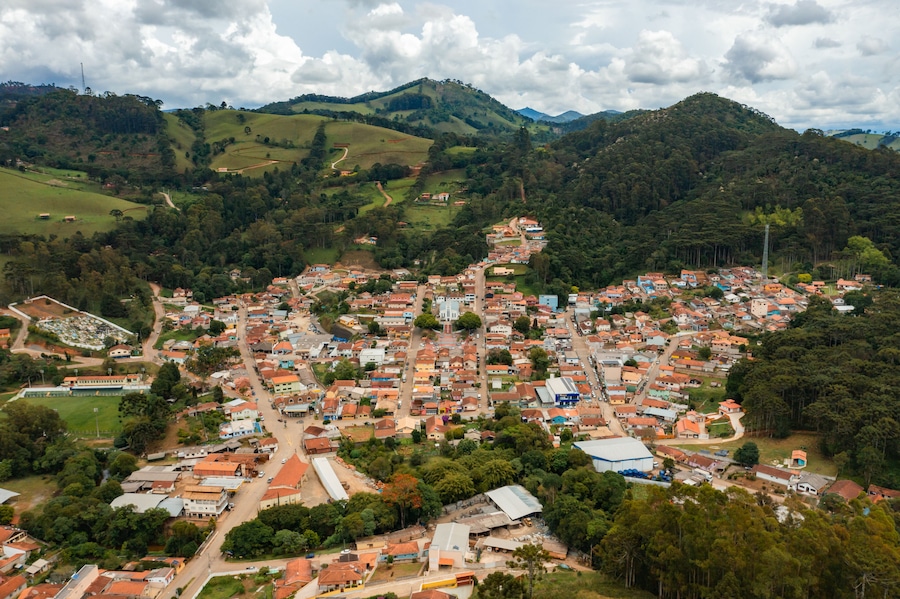 A town nestled in a valley surrounded by hills, with a mix of residential and commercial buildings.