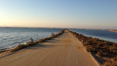 When you visit San Pedro del Pinatar, make sure to take a wall up the pier near the old wind mill. At the end there's another one. You could go further but you'd walk into the sea. This pier is one of the arms that almost close the Mar Menor. You should time it so that you walk back when the sun starts to set. Seeing the sun set behind the houses, the mountains and into the sea is wonderful.