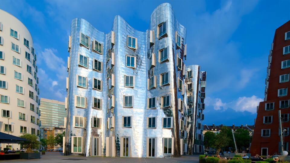 A modern building with a unique curved design and reflective glass facade.