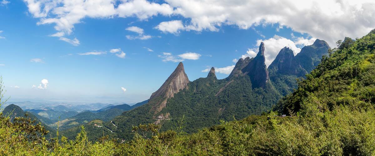 A mountainous landscape with prominent peaks and lush greenery.