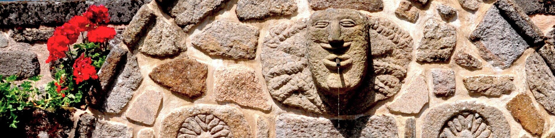 This chateau was left to rot when the dam was filled, but eventually the utility company restored it, crazy horse trough and all...