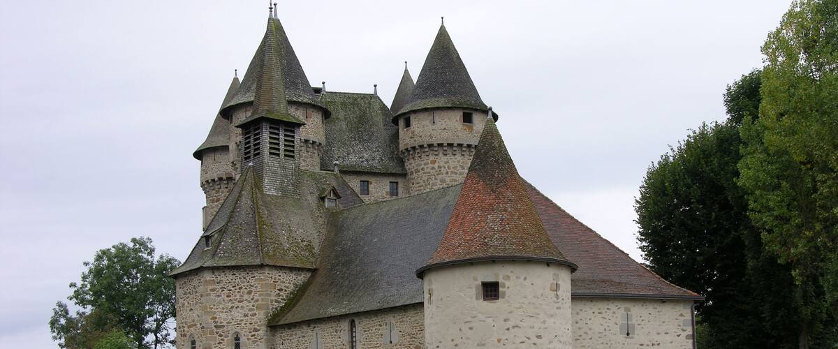 A historic stone castle with multiple towers and a large central building.