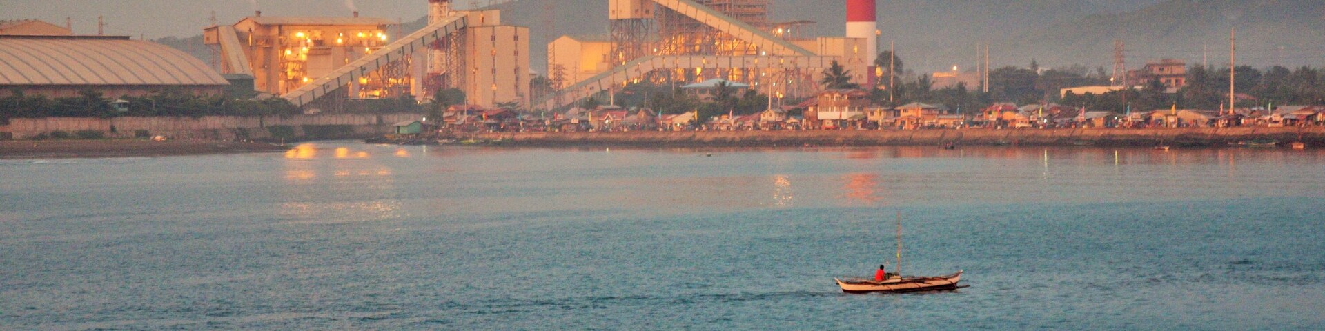 The setting sun was shining on the coal power plant in Toledo City, Cebu as the boat I took from Negros Island gets closer to the port.