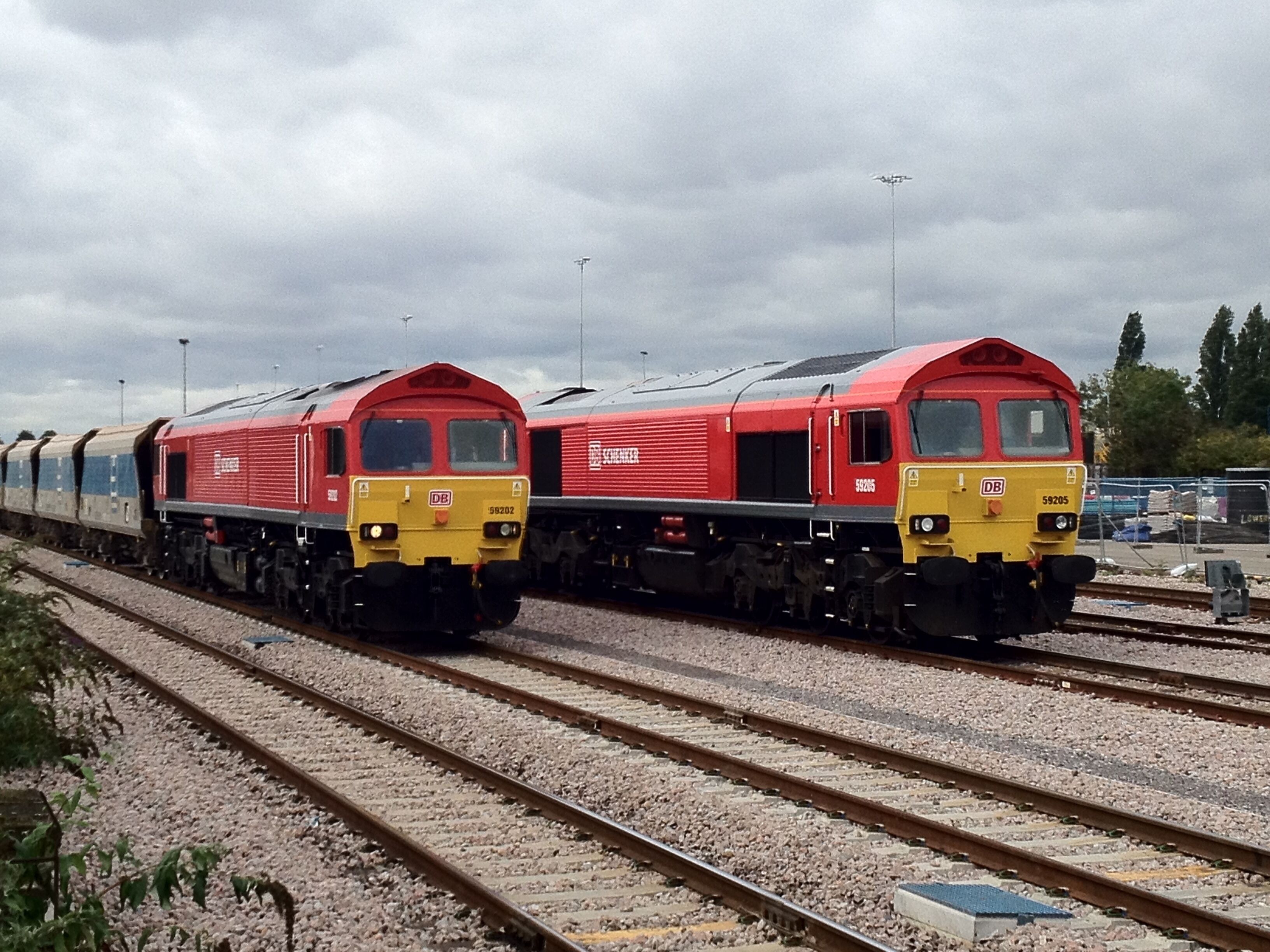 British Rail class 59 locomotives 59 202 and 59 205 in the freight sidings adjacent to Acton Main Line railway station, London. The locomotives are in DB Schenker livery.
