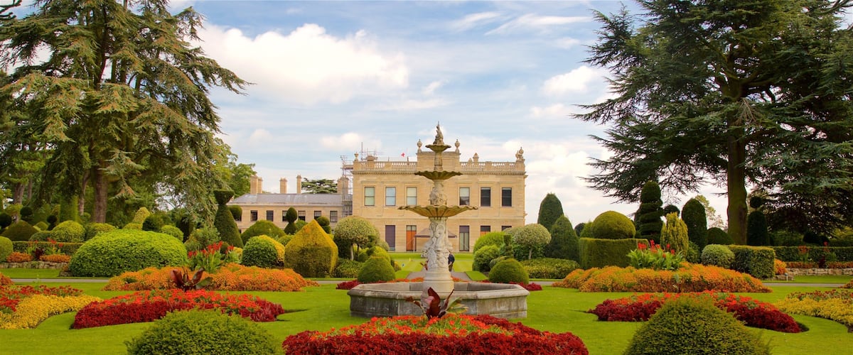 Brodsworth Hall featuring a fountain, a garden and flowers