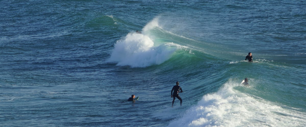 A surfer riding a wave in the ocean.
