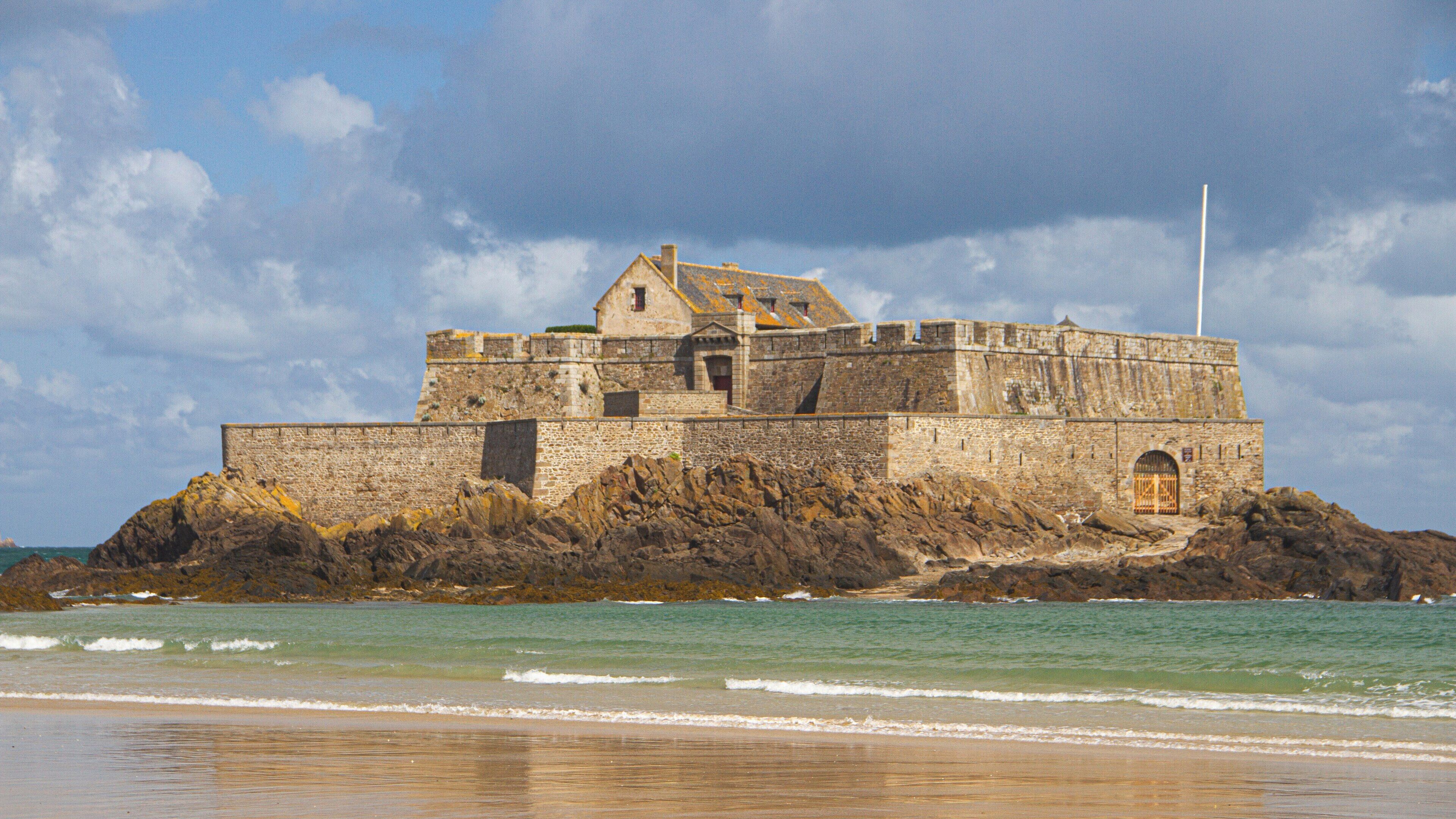Exploring Fort National in Saint-Malo, Brittany, France with its majestic coastline and vibrant sky