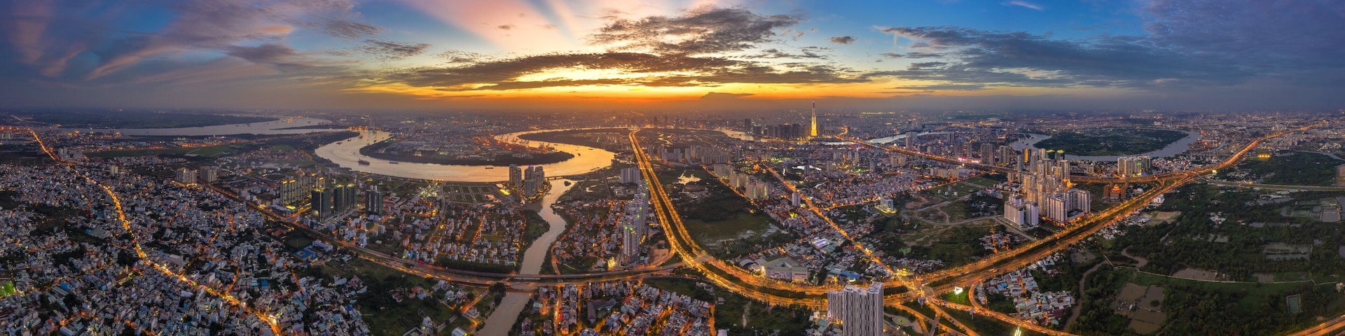 Top view aerial of Mai Chi Tho road, Thu Thiem peninsula and center Ho Chi Minh City, Vietnam with development buildings, transportation, energy power infrastructure. View from District 2