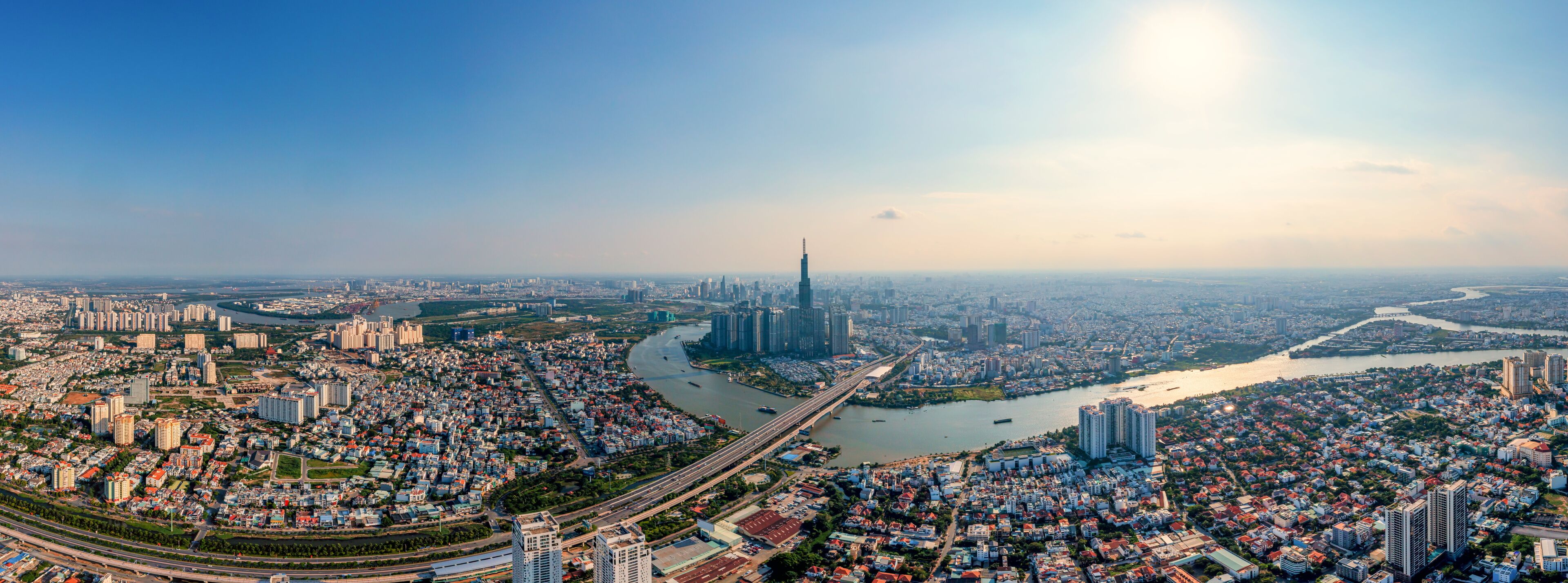 A cityscape with a prominent skyscraper, a river, and surrounding residential areas.