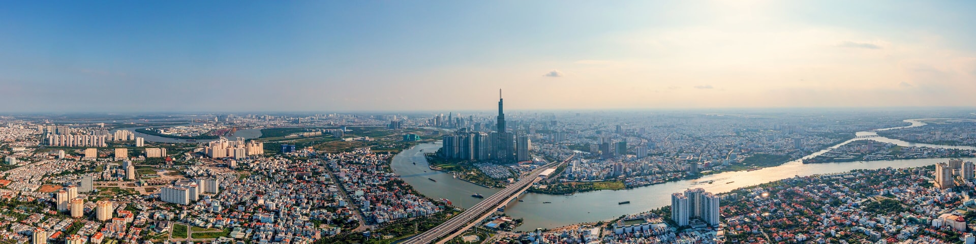 A cityscape with a prominent skyscraper, a river, and surrounding residential areas.