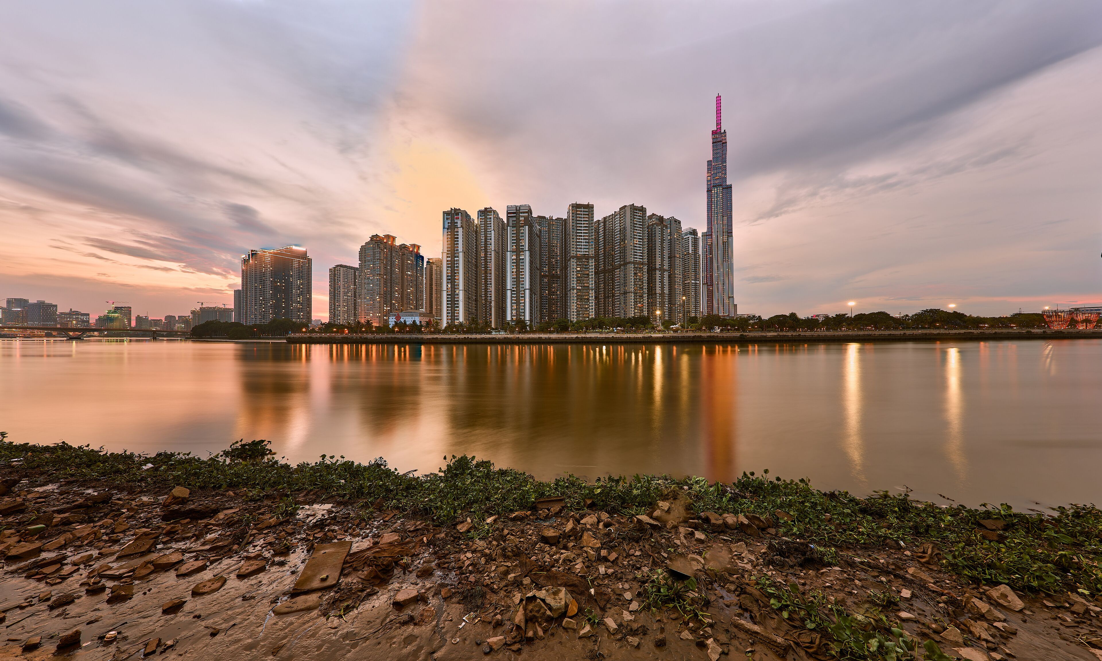 Ho Chi Minh, Viet Nam - 12 July 2023: Ho Chi Minh City skyline and the Saigon River at sunset. Ho Chi Minh City is a popular tourist destination of Vietnam.