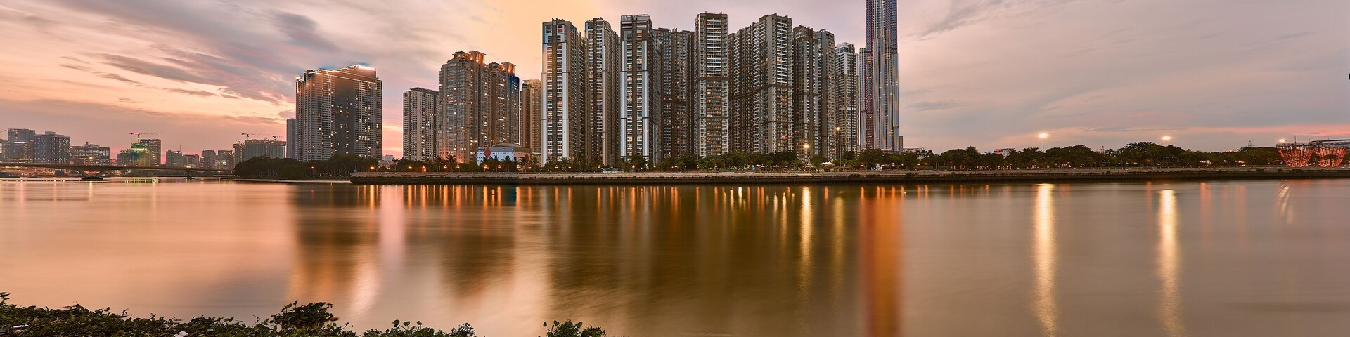 Ho Chi Minh, Viet Nam - 12 July 2023: Ho Chi Minh City skyline and the Saigon River at sunset. Ho Chi Minh City is a popular tourist destination of Vietnam.