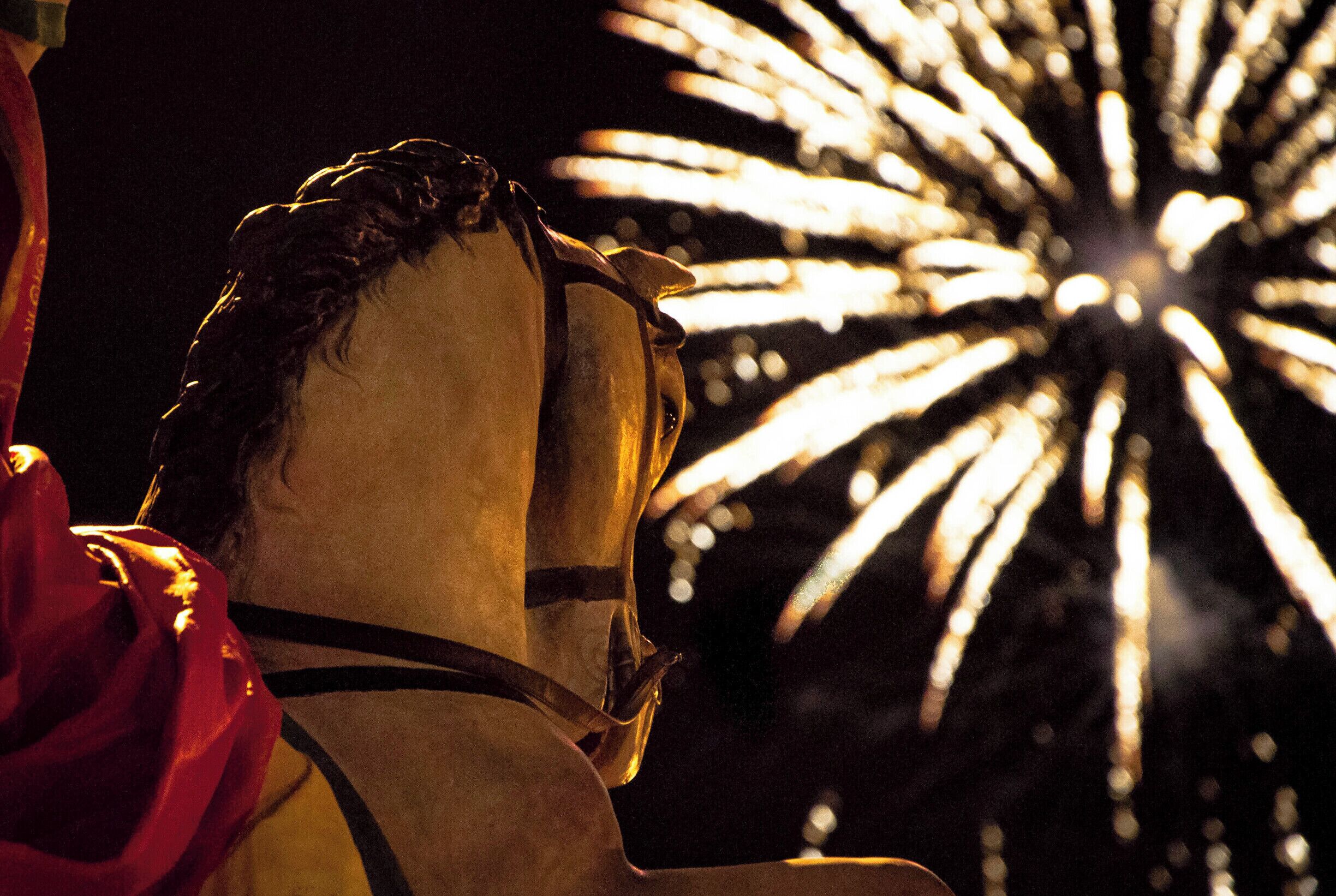 The statue of Saint George and the fireworks. Saint George and Saint Fortunato festival in Ortelle.