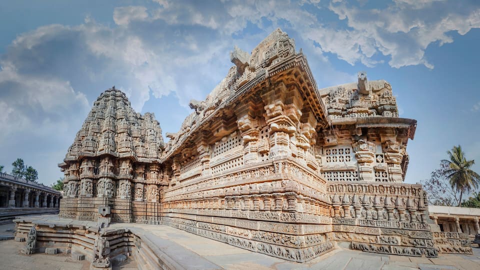 A large, intricately carved temple with multiple spires and detailed sculptures.