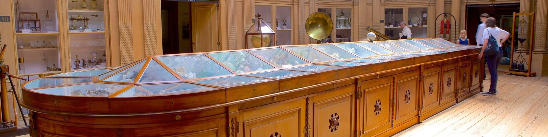 A large, ornate wooden cabinet with glass display cases in a museum.