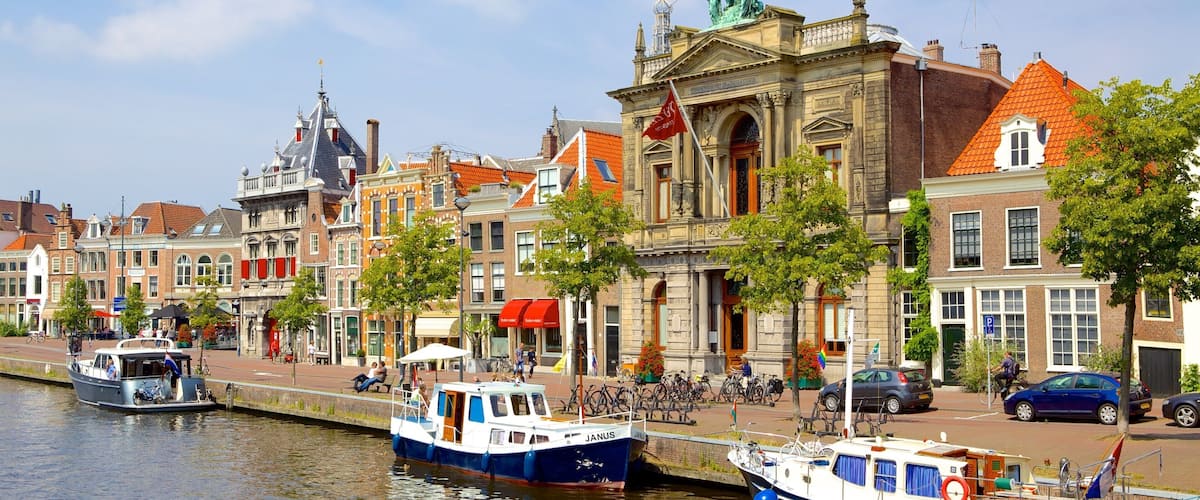 Teylers Museum featuring a bay or harbor, a house and boating