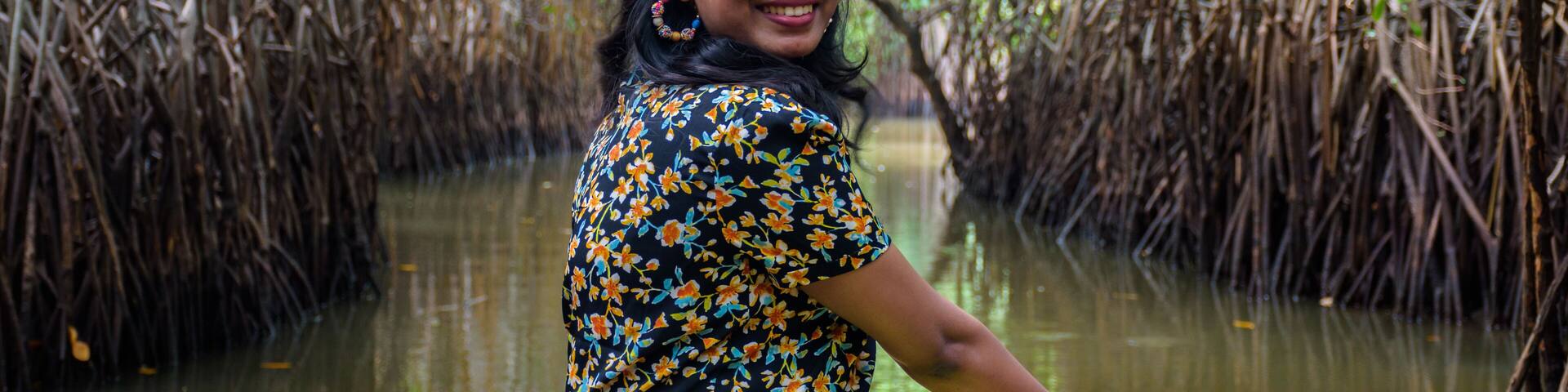 Young Indian woman boating through Pichavaram Mangrove Forests. The second largest Mangrove forest in the world, located near Chidambaram in Cuddalore District, Tamil Nadu, India