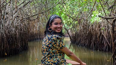 Young Indian woman boating through Pichavaram Mangrove Forests. The second largest Mangrove forest in the world, located near Chidambaram in Cuddalore District, Tamil Nadu, India