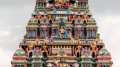 A colorfully decorated tower with mythological figures and deities in an ancient Hindu temple in Tamil Nadu.