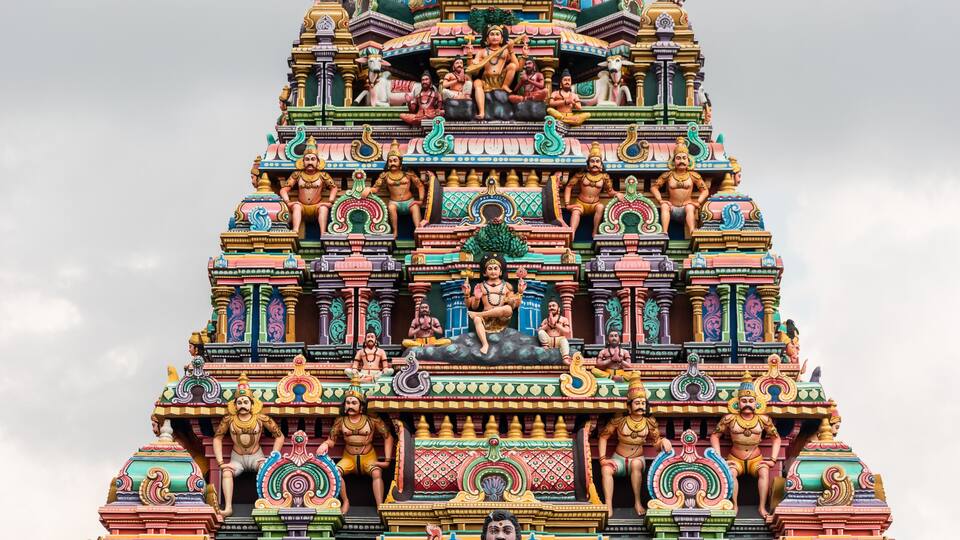 A colorful temple with intricate carvings and statues.