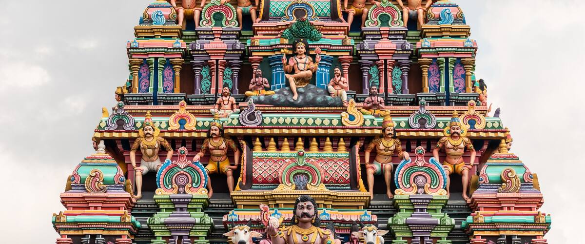 A colorful temple with intricate carvings and statues.