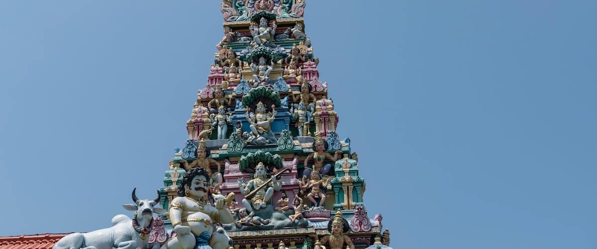 A multi-tiered temple with intricate carvings and statues.
