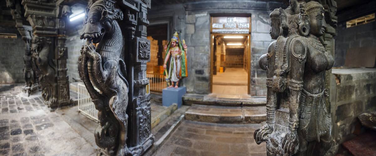 Ornate stone carvings of deities and a temple entrance.