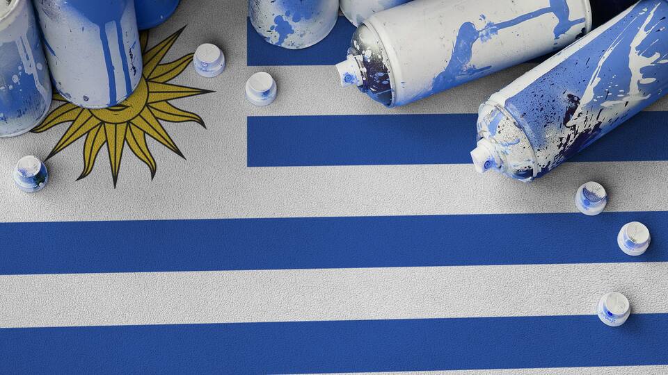 Spray-painted blue and white stripes, a sun design, and paint cans.