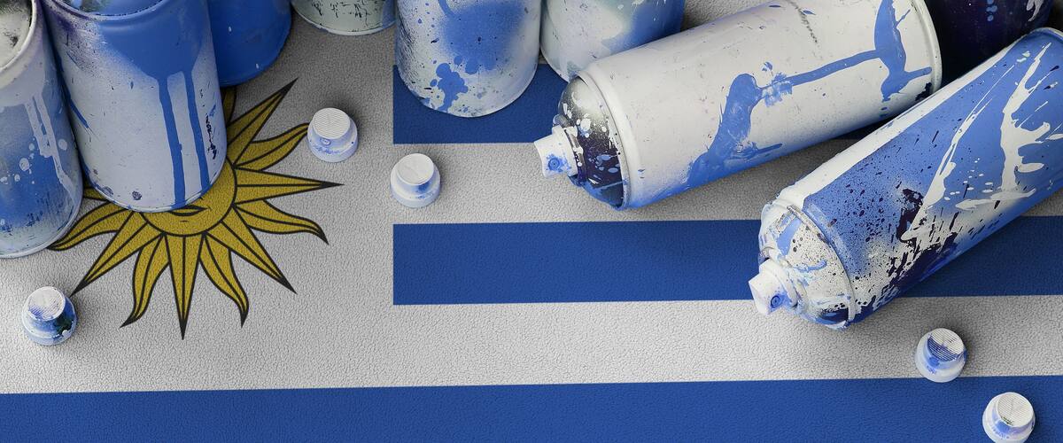 Spray-painted blue and white stripes, a sun design, and paint cans.