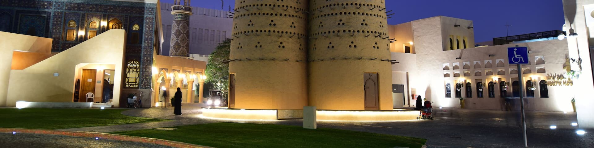 A modern building with two tall, cylindrical towers with a pattern of holes.