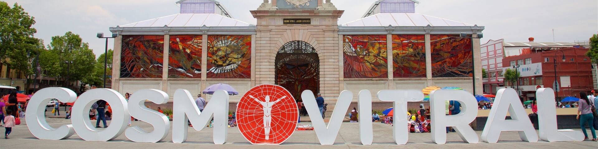 A large outdoor sign with the text "COSMIVITRAL" and a red circular logo.