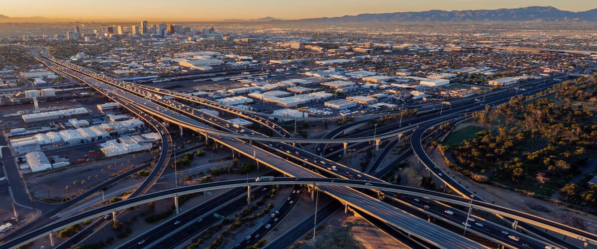 Interstate Freeway junction and rush hour traffic at sunrise. Maryvale, Phoenix, Arizona, United States of America.