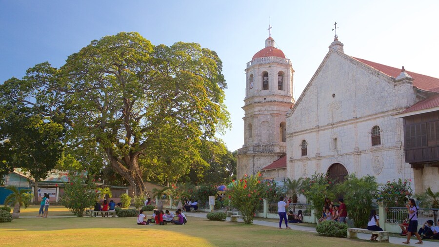 Dalaguete Church showing religious aspects, heritage architecture and a sunset