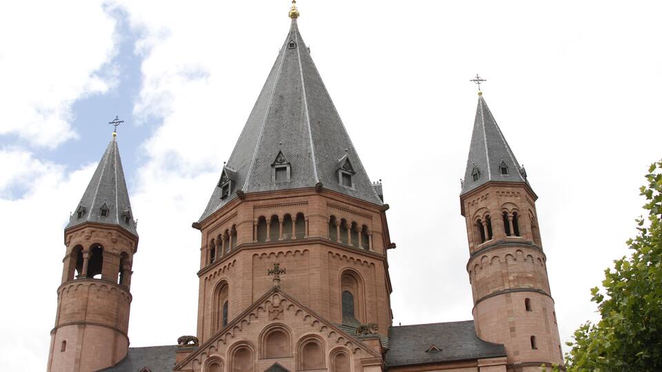 A large church with three spires and a central tower.