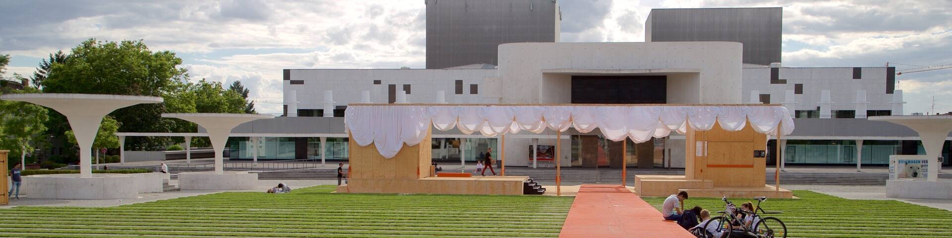 Darmstadt State Theatre featuring modern architecture and a garden as well as a small group of people