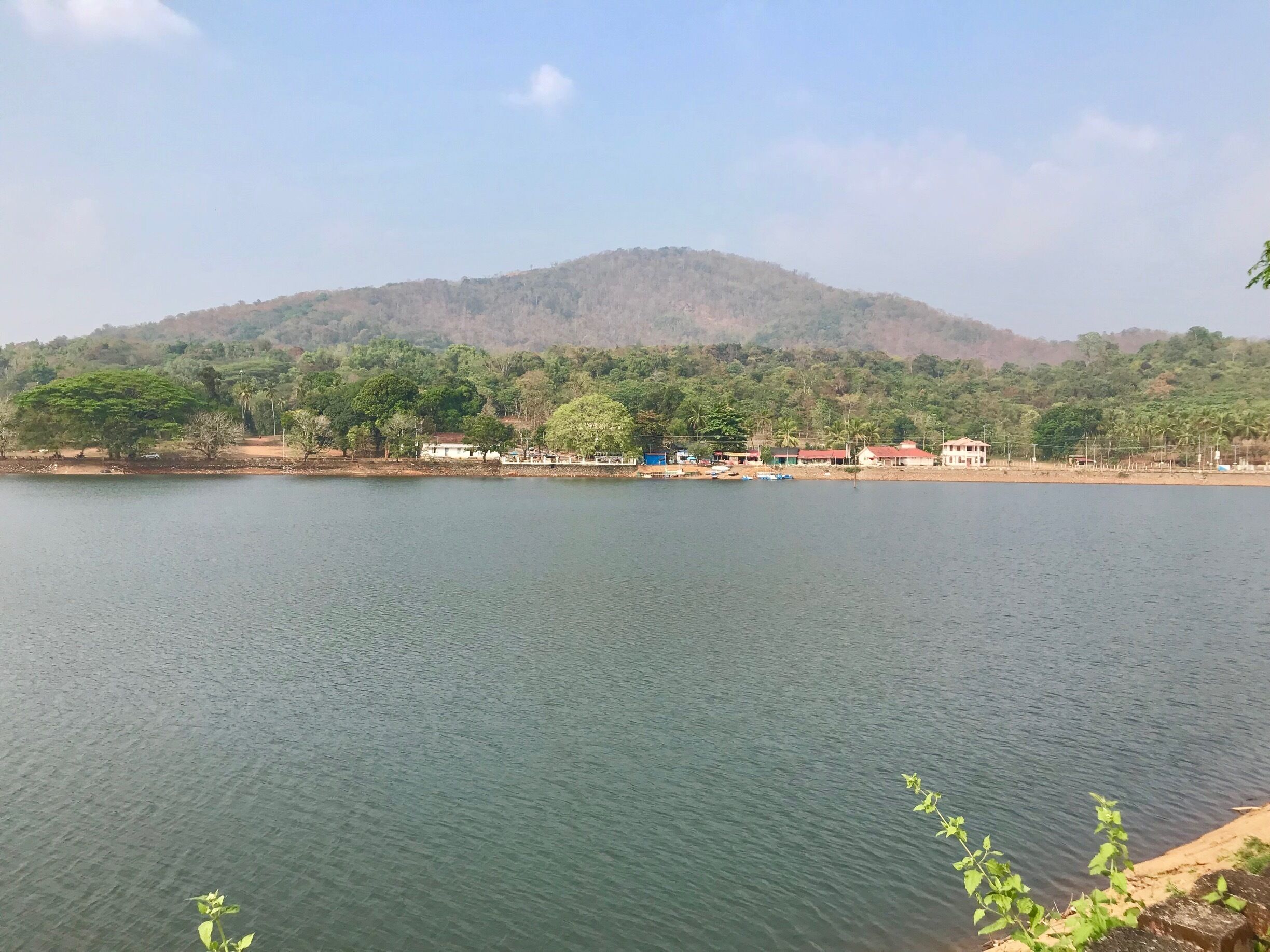 A calm lake with a mountain in the background.