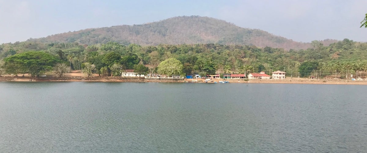 A calm lake with a mountain in the background.